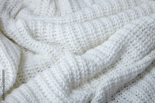 A full page close up of cream knitted fabric texture