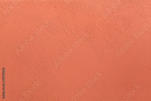 Terracotta painted stucco wall. Background texture