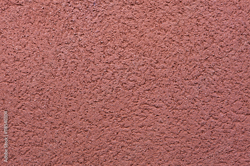 Burgundy red painted stucco wall. Background texture