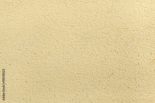Yellow painted stucco wall. Background texture