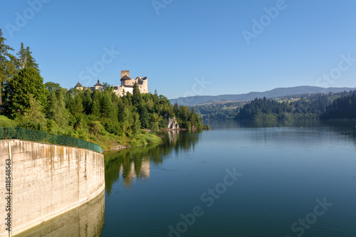 A view of medieval Dunajec castle from dam in Niedzica. Pieniny Mountains, Poland. Europe.