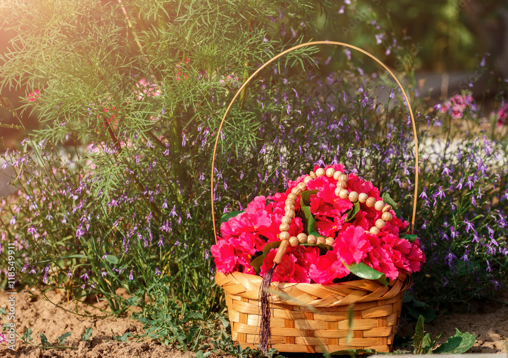 background with rosary and flowers on nature outdoors, closeup. 