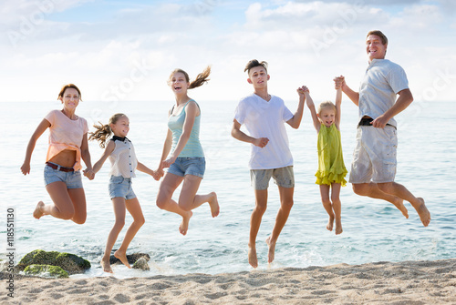Parents with four children jumping