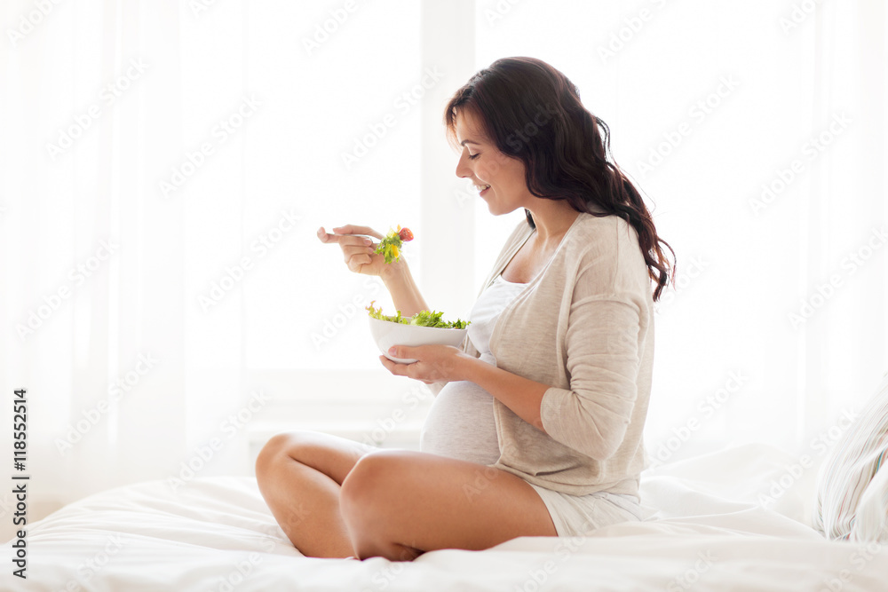 happy pregnant woman eating salad at home happy pregnant woman eating salad at home
