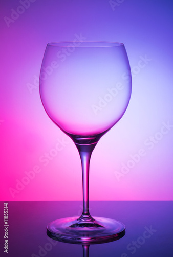 Glass glass of wine on a colored background