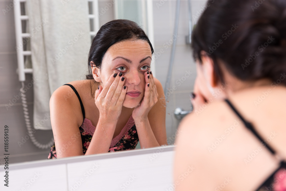 Close up young washing face standing in front of mirror Close up young washing face standing in front of mirror