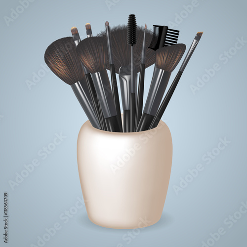 Set of Realistic Make Up Brushes standing in a glass. Vector illustration