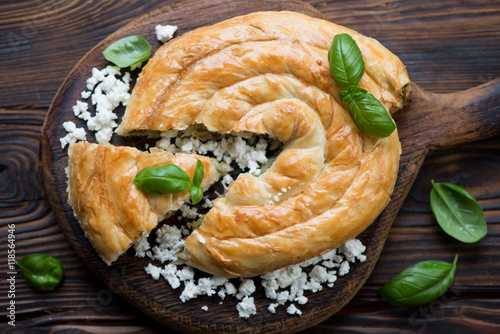Burek or burekas with cheese and spinach, top view, close-up