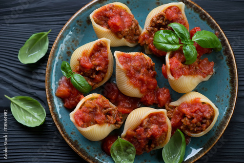 Conchiglioni stuffed with mincemeat and baked in tomato sauce