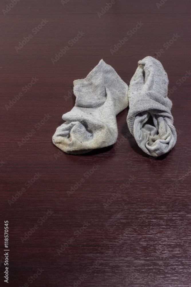 Used dirty socks on wooden floor Stock Photo | Adobe Stock