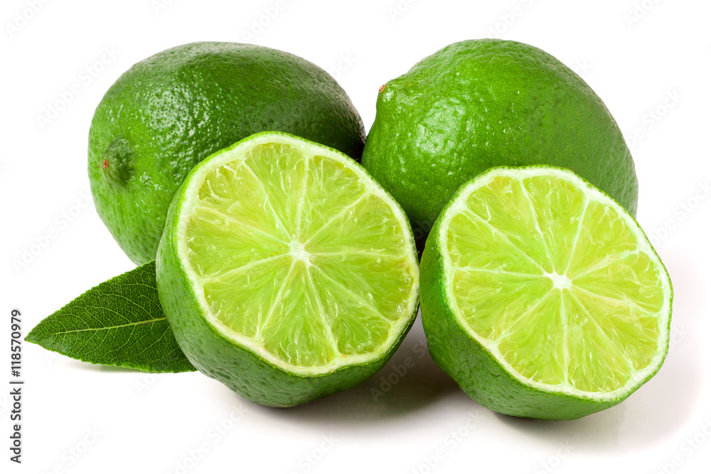 two limes with halves and leaf isolated on white background