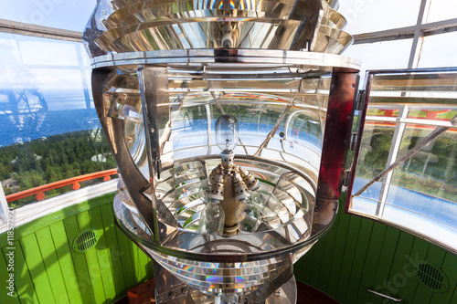 Lighthouse glass lamp and view on the sea
