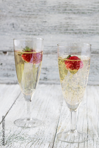 two champagne glasses and strawberries