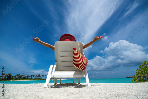 Fotografia, Obraz Young woman sunbathing on lounger at tropical beach