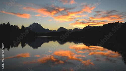 Fast motion view of bright colorful sunset reflected in the Snake River in Grand Teton National Park in Wyoming photo