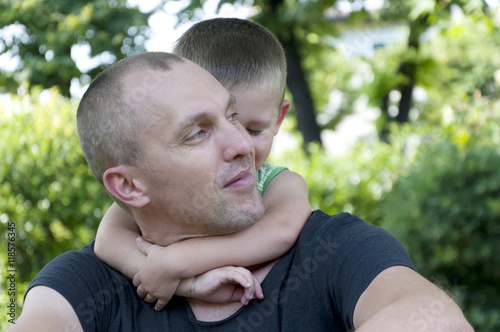 child hugging his father in the park