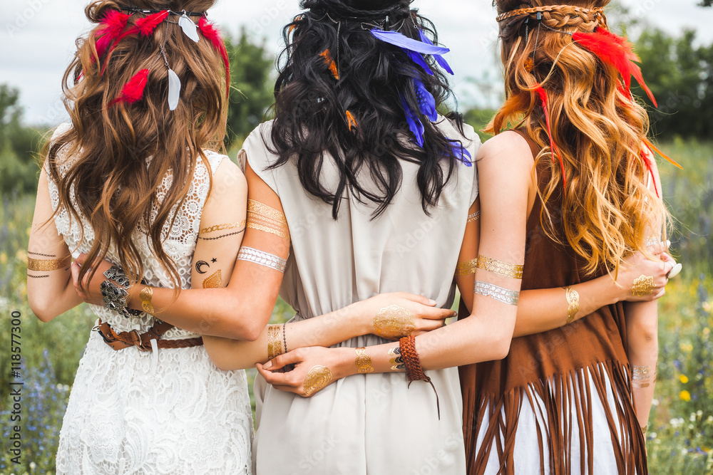 Three beautiful cheerful hippie girls, best friends, the outdoors