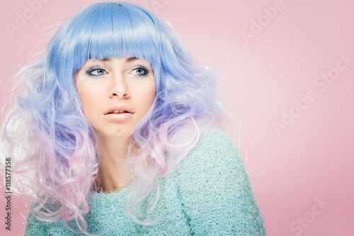 Gorgeous young woman with pastel blue and pink hair. Fashion model with colorful hair