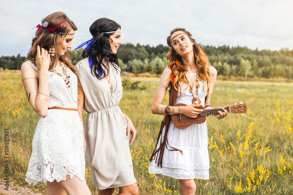 Summer holidays, travel and people concept -Three beautiful cheerful hippie  girls, best friends, trendy hairstyles, feathers in her hair, white dress,  tattoo flash, accessories, Bohemian, Boho Style Stock Photo | Adobe Stock