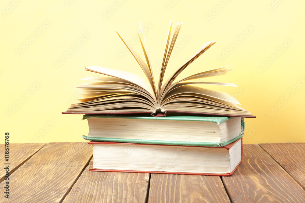 Open book, hardback books on wooden table. Education background. Back to school. Copy space for text. Open book, hardback books on wooden table. Education background. Back to school. Copy space for text.
