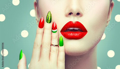 Watermelon nail art and makeup closeup over polka dots background