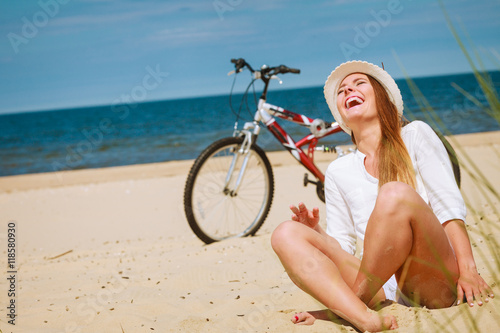 Girl with bike on beach.