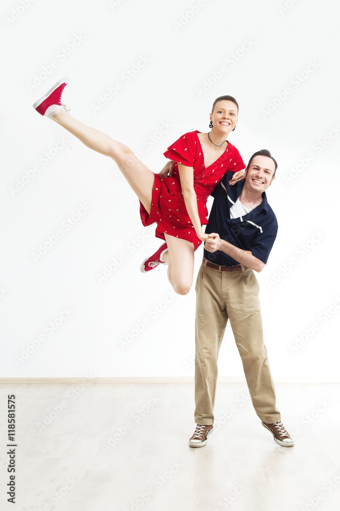 Rock'n'roll dance boogie woogie. Boogie acrobatic stunt in a studio on the  white background. Dance for rock-n-roll music. Stock-Foto | Adobe Stock