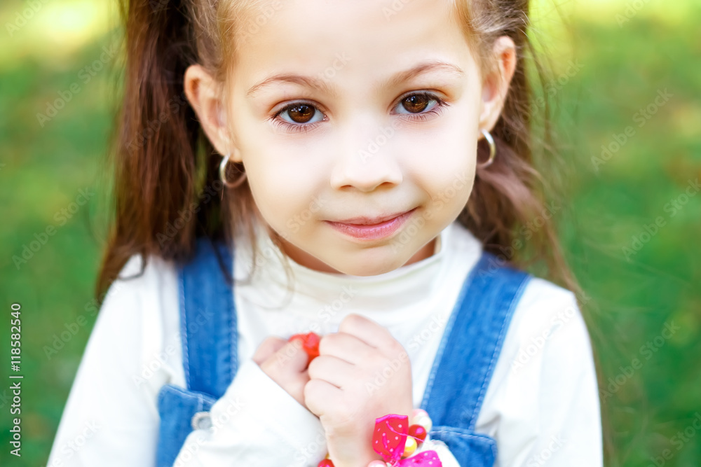 Sweet little girl outdoors with curly hair in two long tails, closeup portret. Sweet little girl outdoors with curly hair in two long tails, closeup portret.
