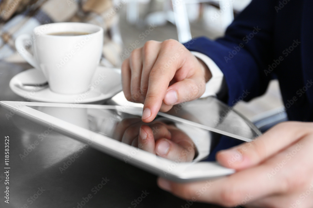 Businessman with tablet in cafe Businessman with tablet in cafe