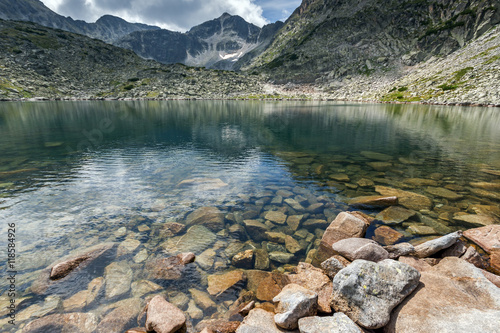 Stones in the water and reflection of Musalenski lakes, Rila mountain, Bulgaria