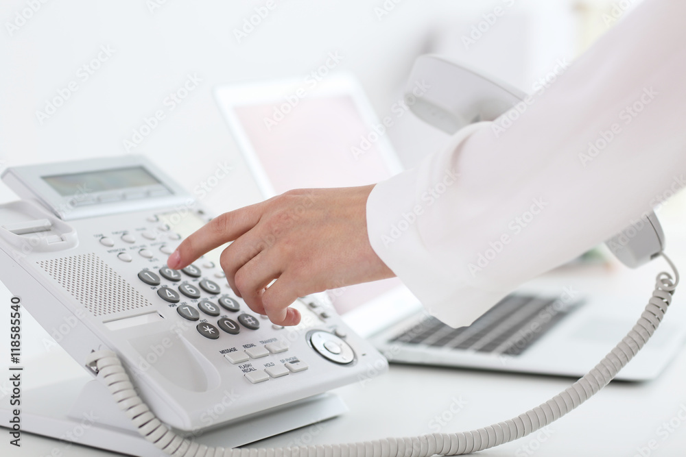 Businesswoman with office IP telephone