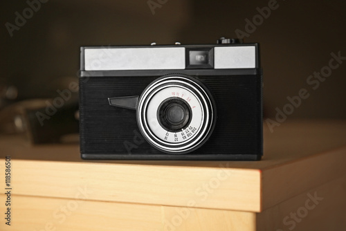 Retro camera on wooden surface closeup