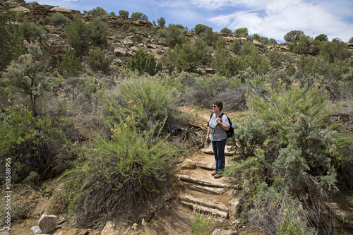 Hiker on a trail at Hovenweep National Monument photo