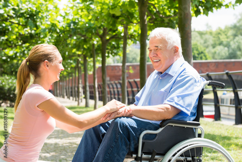 Young Woman Holding Hands Of Her Disabled Father © Andrey Popov