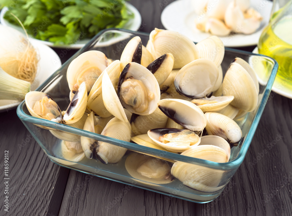 clams ready for cooking on wood board clams ready for cooking on wood board