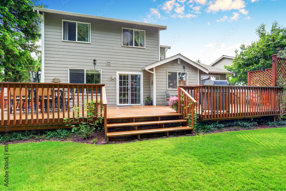 Back yard house exterior with spacious wooden deck - obrazy, fototapety, plakaty 