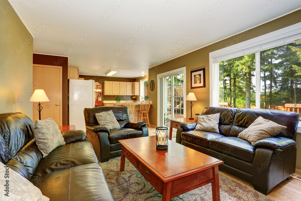 Cozy living room with leather sofas and brick fireplace. Cozy living room with leather sofas and brick fireplace.