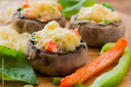Stuffed mushrooms with vegetables on wooden board