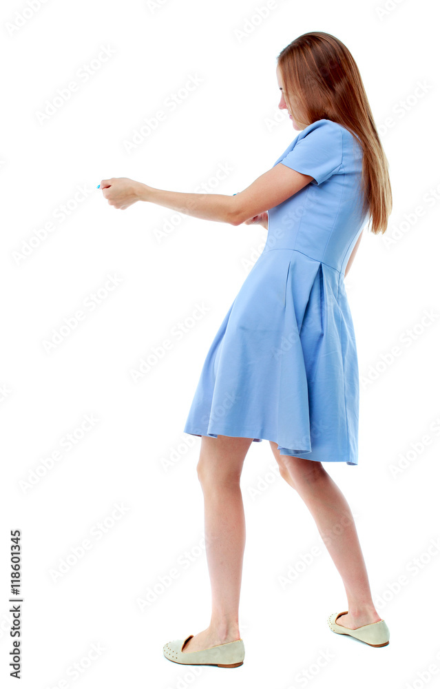 back view of standing girl pulling a rope from the top or cling to something. girl watching. Rear view people collection. backside view of person. Isolated over white background. Skinny girl in a back view of standing girl pulling a rope from the top or cling to something. girl watching. Rear view people collection. backside view of person. Isolated over white background. Skinny girl in a