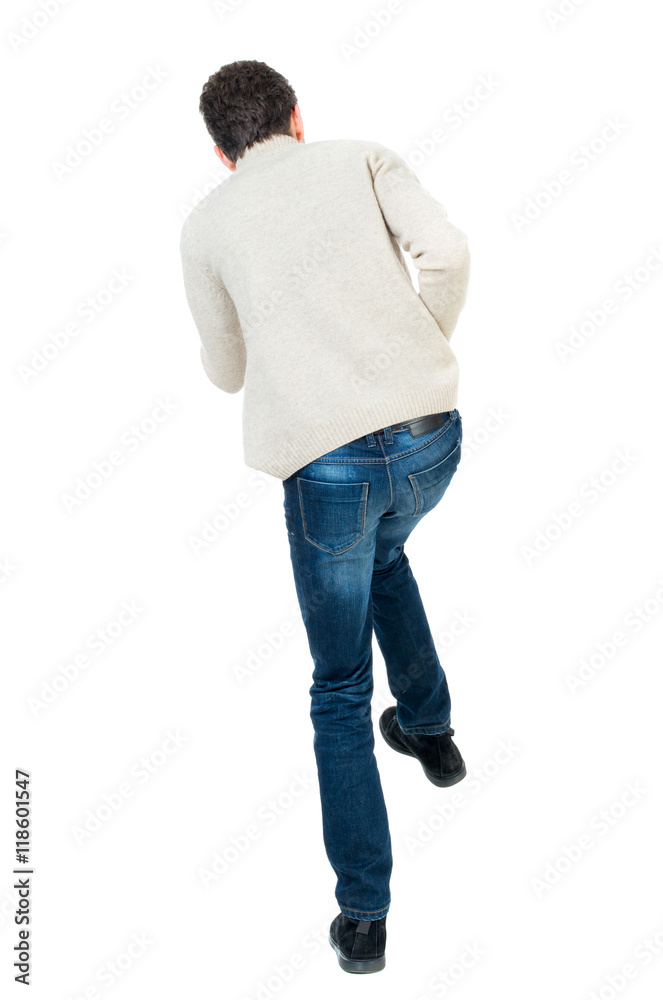 back view of guy funny fights waving his arms and legs. Isolated over white background. Rear view people collection. backside view of person. Curly short-haired man in a woolen white jacket jumping back view of guy funny fights waving his arms and legs. Isolated over white background. Rear view people collection. backside view of person. Curly short-haired man in a woolen white jacket jumping