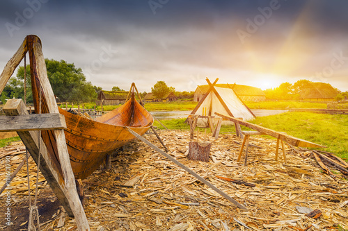  Viking harbor with old boat in Denmark at sunset photo