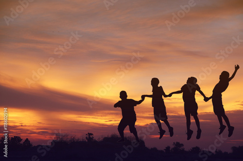 Stock Photo:.Silhouette the boy jumping over sunset