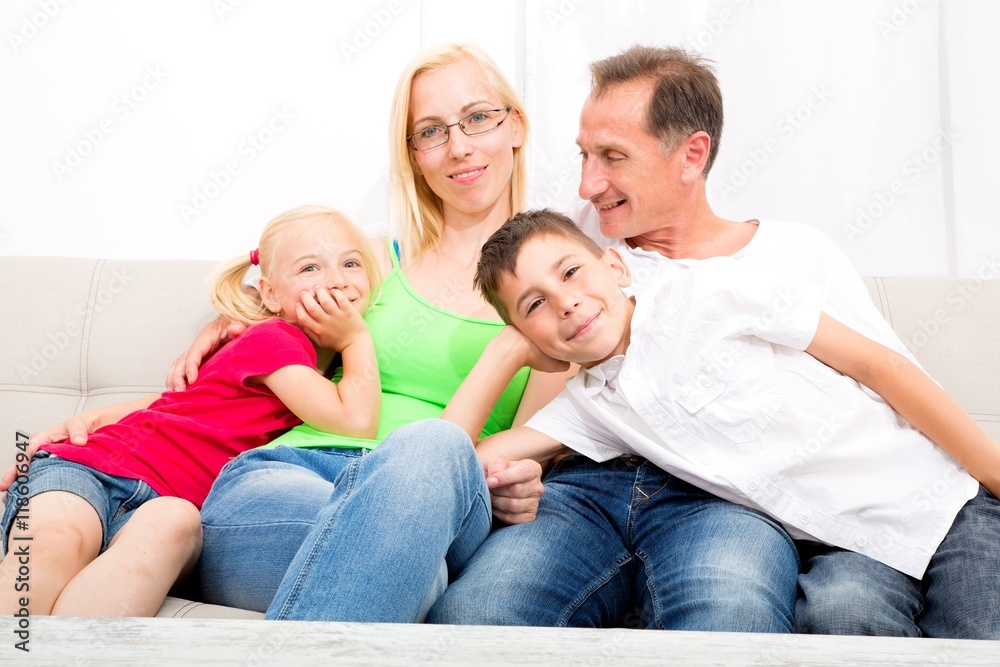 Happy family sitting together on the couch. Happy family sitting together on the couch.