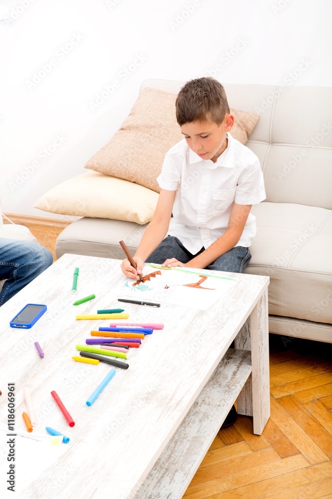 A father is sitting on the couch while his son is drawing.. A father is sitting on the couch while his son is drawing..