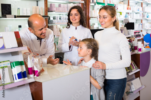 Two pharmacists and customers.