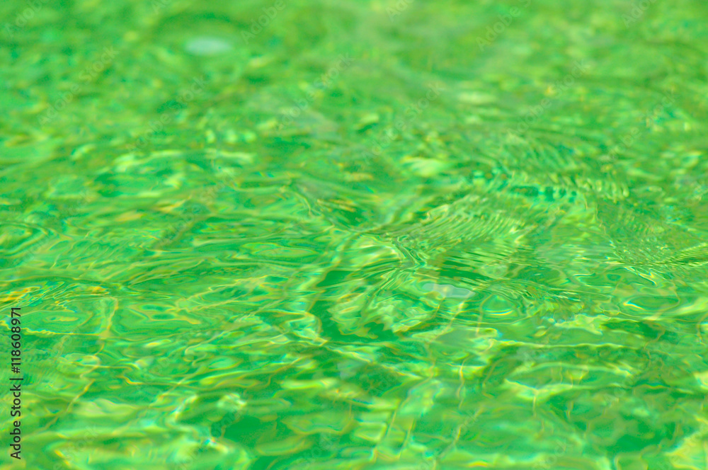 Green water surface with sun reflection in swimming pool Green water surface with sun reflection in swimming pool