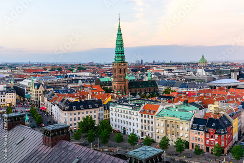 Copenhagen skyline by evening. Denmark capital city streets and danish house roofs. Copenhagen old town and copper spiel of Nikolaj Church panoramic view from top of Christiansborg palace.