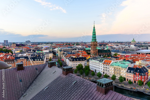 Copenhagen skyline. Denmark capital city streets and danish house roofs. Copenhagen old town and copper spiel of Nikolaj Church panoramic view by evening.