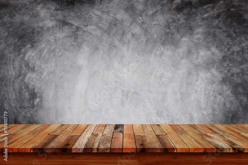 Empty wooden table with bare concrete wall background.