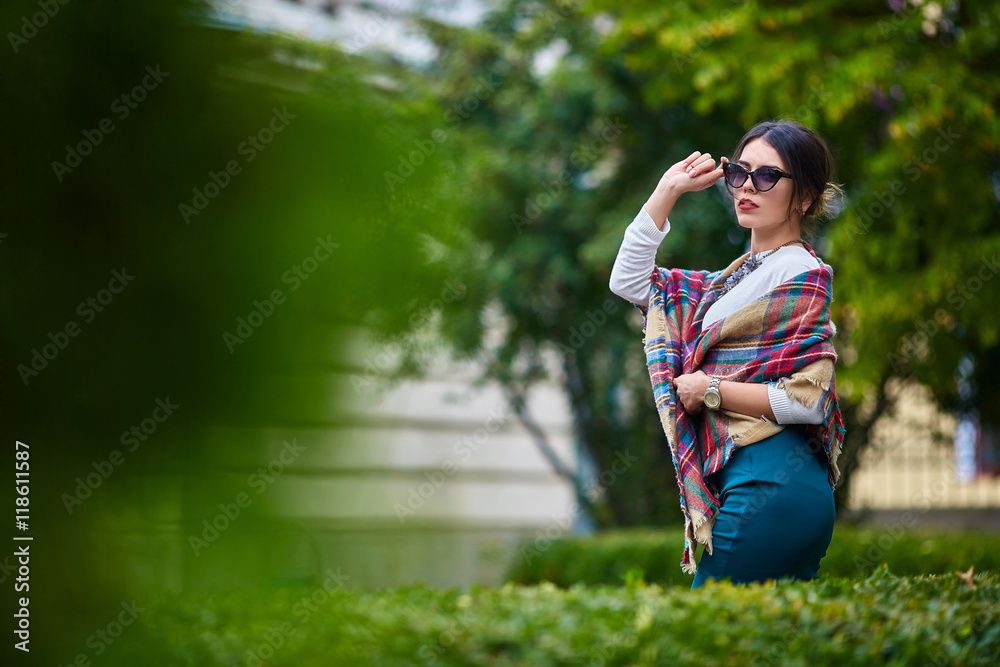 Dreamlike girl walks in sunglasses between the bushes Dreamlike girl walks in sunglasses between the bushes